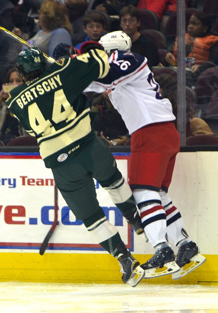 Monsters defenseman Jaime Sifers takes a big hit from an Iowa attacker. Photo by Ryan Kaczmarski