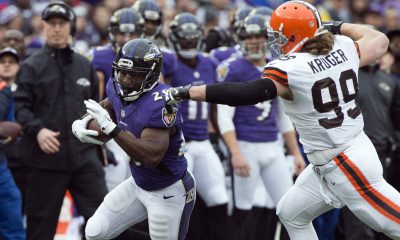 Dec 28, 2014; Baltimore, MD, USA; Baltimore Ravens running back Justin Forsett (29) runs past Cleveland Browns outside linebacker Paul Kruger (99) during the first quarter at M&T Bank Stadium. Mandatory Credit: Tommy Gilligan-USA TODAY Sports