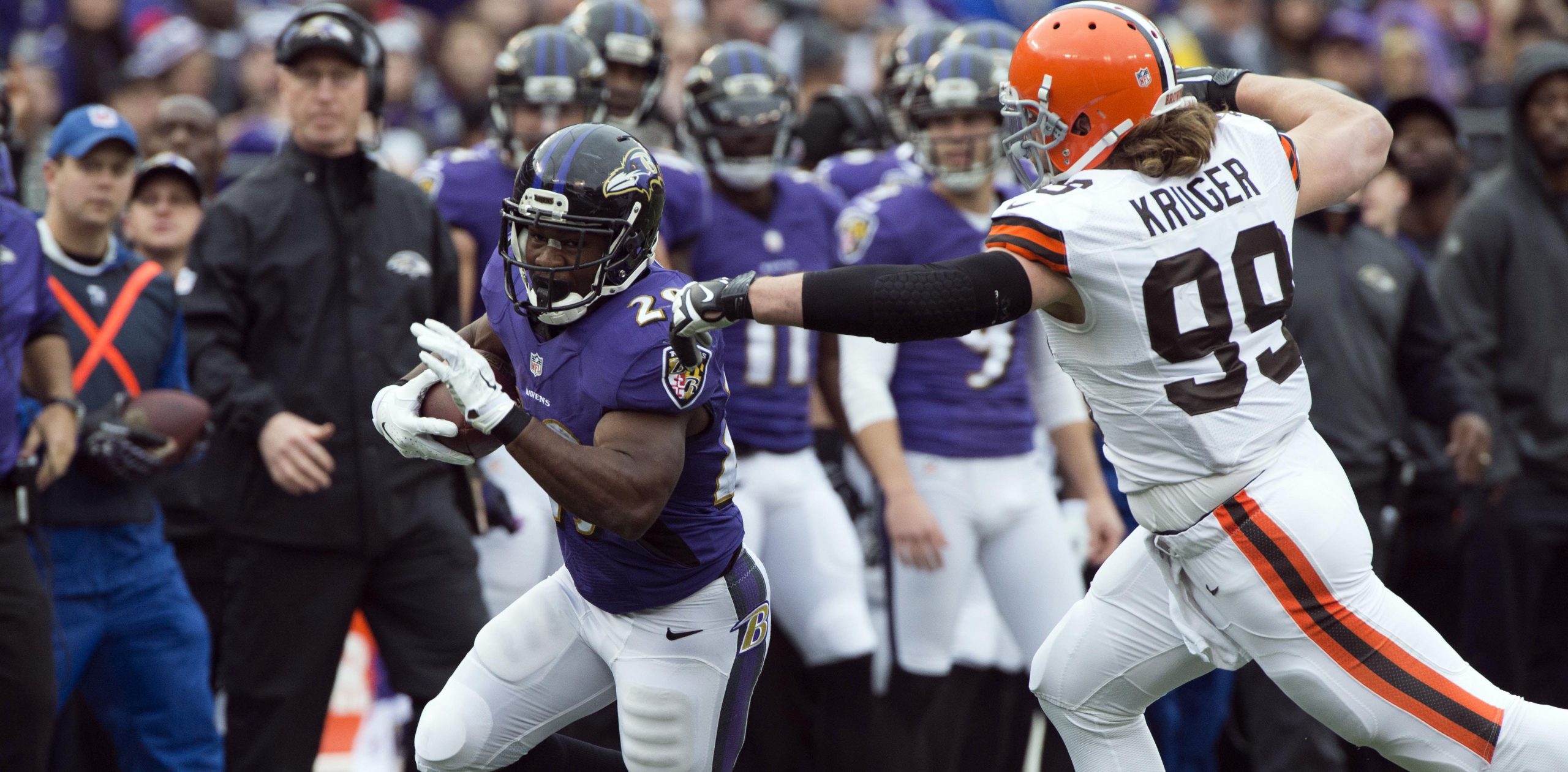 Dec 28, 2014; Baltimore, MD, USA; Baltimore Ravens running back Justin Forsett (29) runs past Cleveland Browns outside linebacker Paul Kruger (99) during the first quarter at M&T Bank Stadium. Mandatory Credit: Tommy Gilligan-USA TODAY Sports